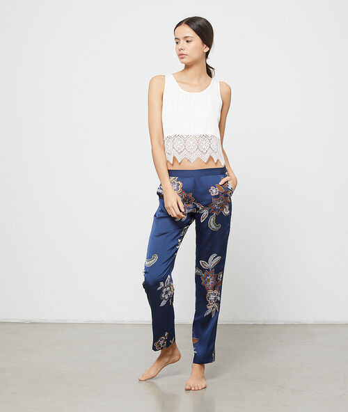 Pantalon imprimé fleuri bleu.